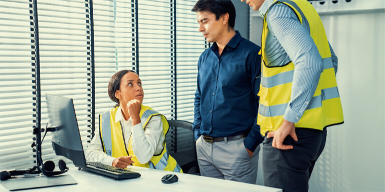 3 construction professionals talking at a table