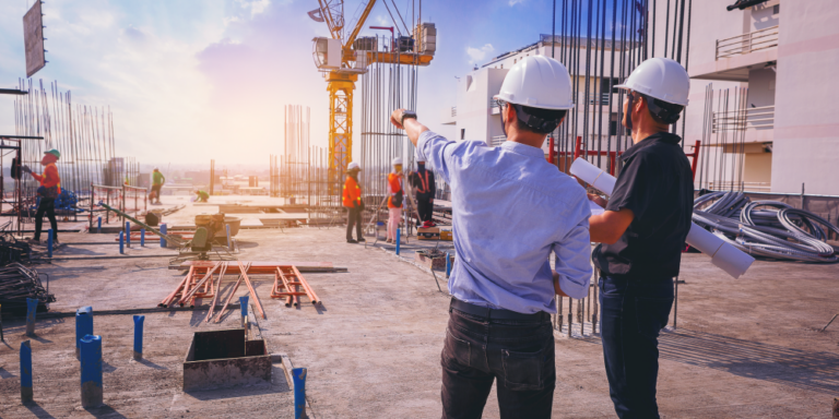 Two workers overlooking a construction site