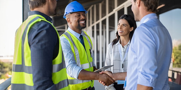 4 construction professionals forming construction partnerships and shaking hands