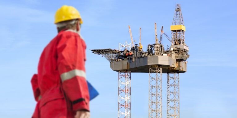 View of a person observing an oil rig construction project.