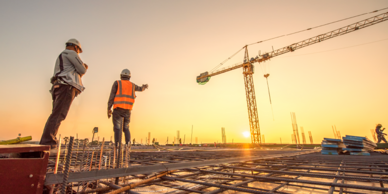 Crane inspection with 2 workers in the foreground and crane in the background