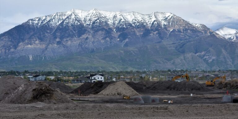 Construction on tribal land — construction equipment in a remote mountain landscape