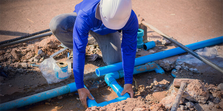 Plumber laying pipe on a construction jobsite