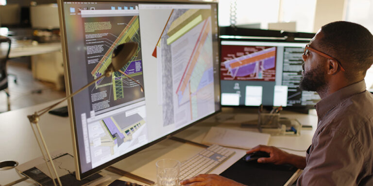 Virtual design and construction technology being used via models on an office desktop