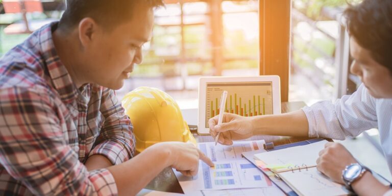 Estimate vs budget — two construction pros comparing and contrasting data