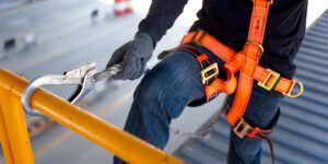 Construction worker use safety harness and safety line working at hight on a new construction site project.