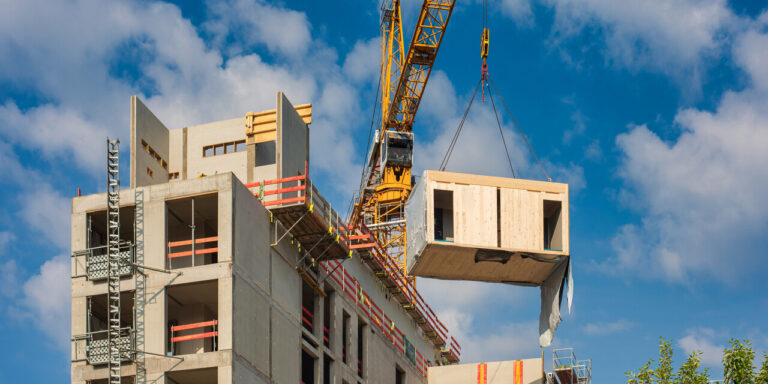 Construction site of an office building in Berlin. The new structure will be built in modular timber construction. MODULAR WOODEN HOUSES made out of renewable resources.