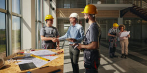 Construction office manager onsite with other workers