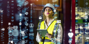 Cybersecurity in construction illustrated by construction pro using tablet surrounded by visualizations of tech symbols and numbers