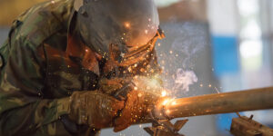 Milcon worker welding on a construction site