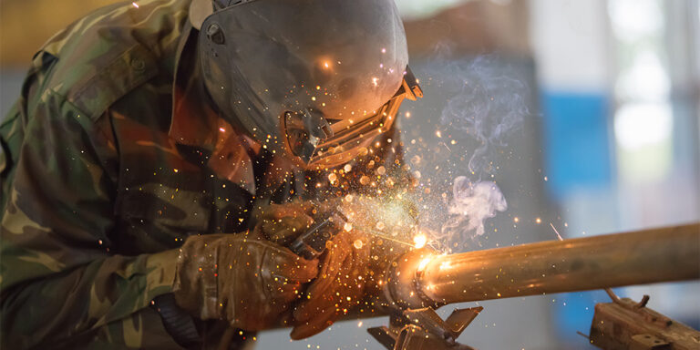 Milcon worker welding on a construction site