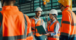 Construction workers in PPE using construction safety technology