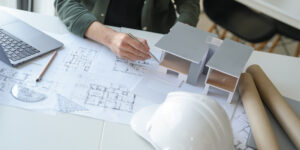 Architect examining drawings and models for construction