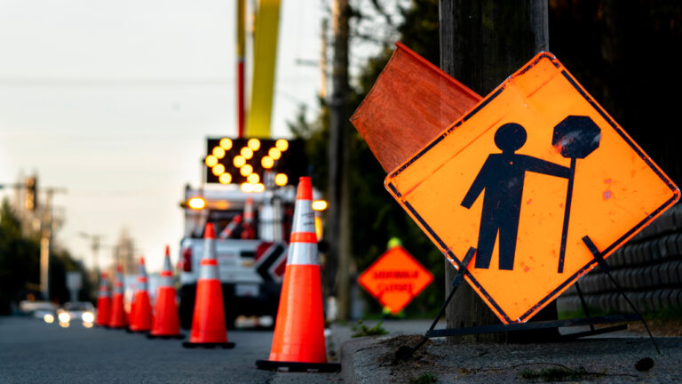 Traffic control plan signs and cones redirecting traffic in a construction zone