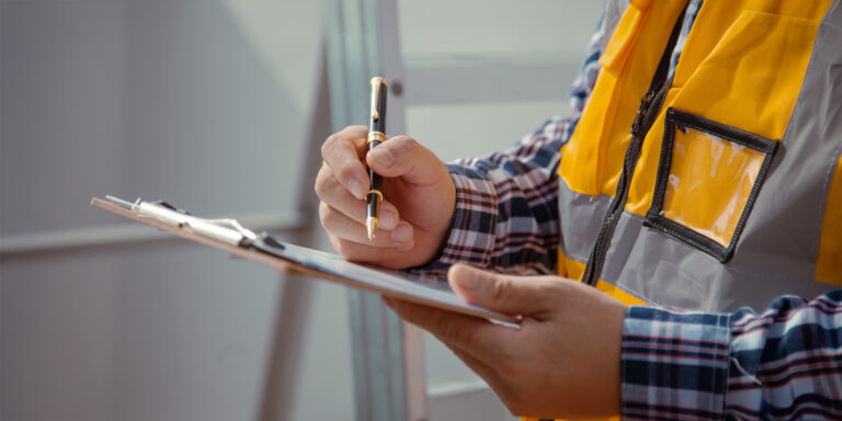 Contractor checking off items on a checklist