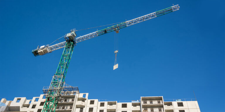 A crane lifting materials on a construction site.