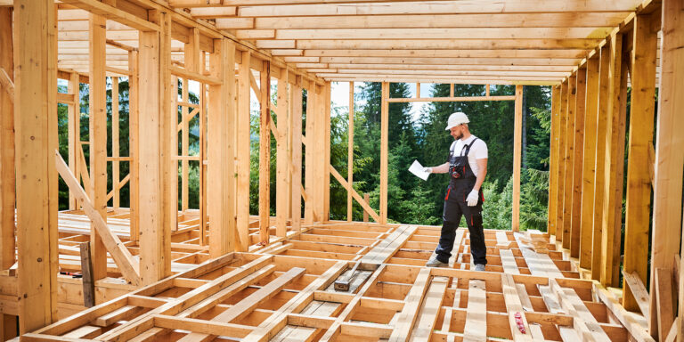 Architect inspecting a wooden frame structure